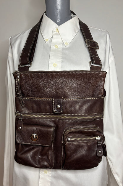 Brown leather crossbody bag on a mannequin with a white shirt