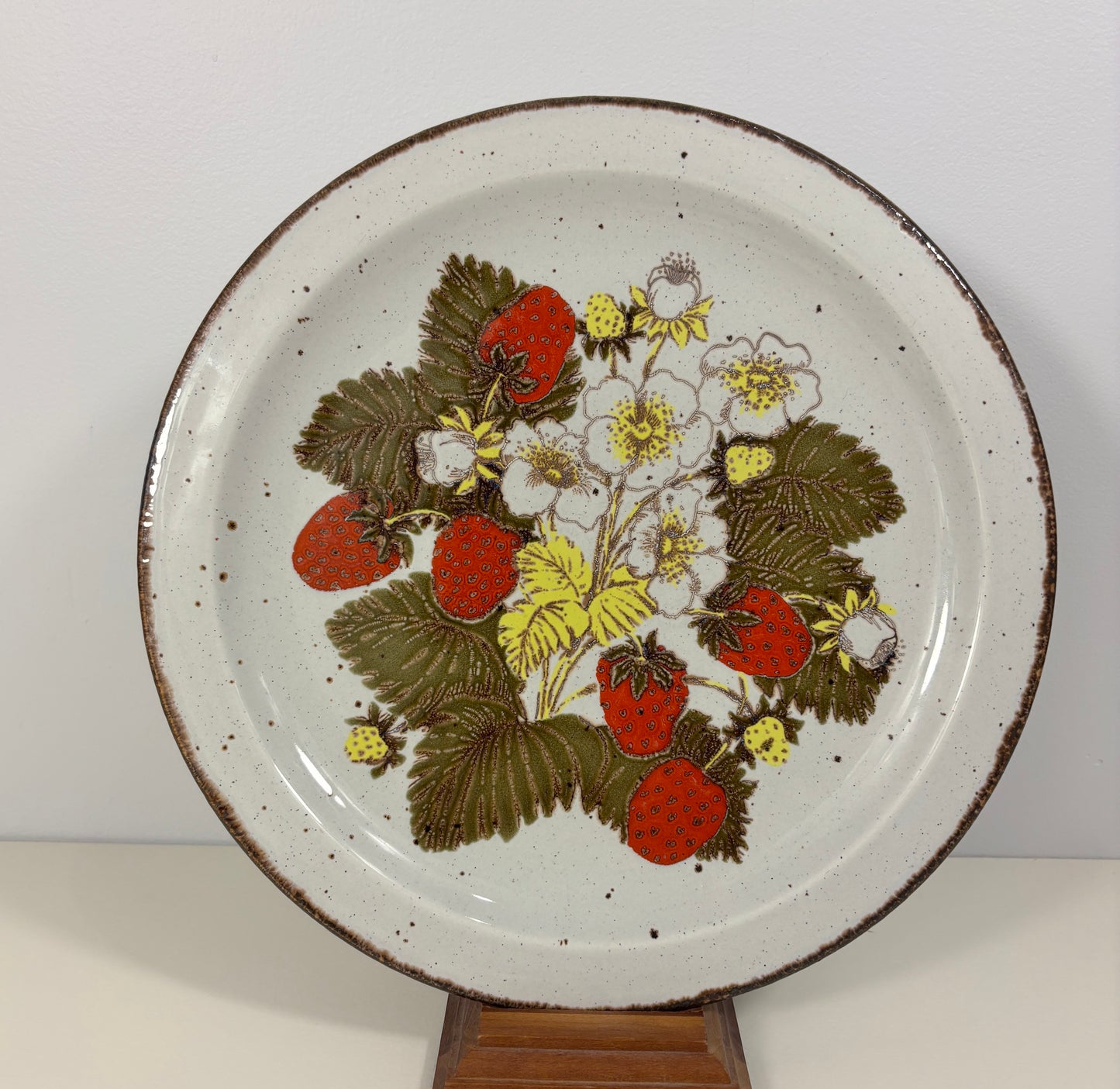 Ceramic plate with strawberry design on a white background