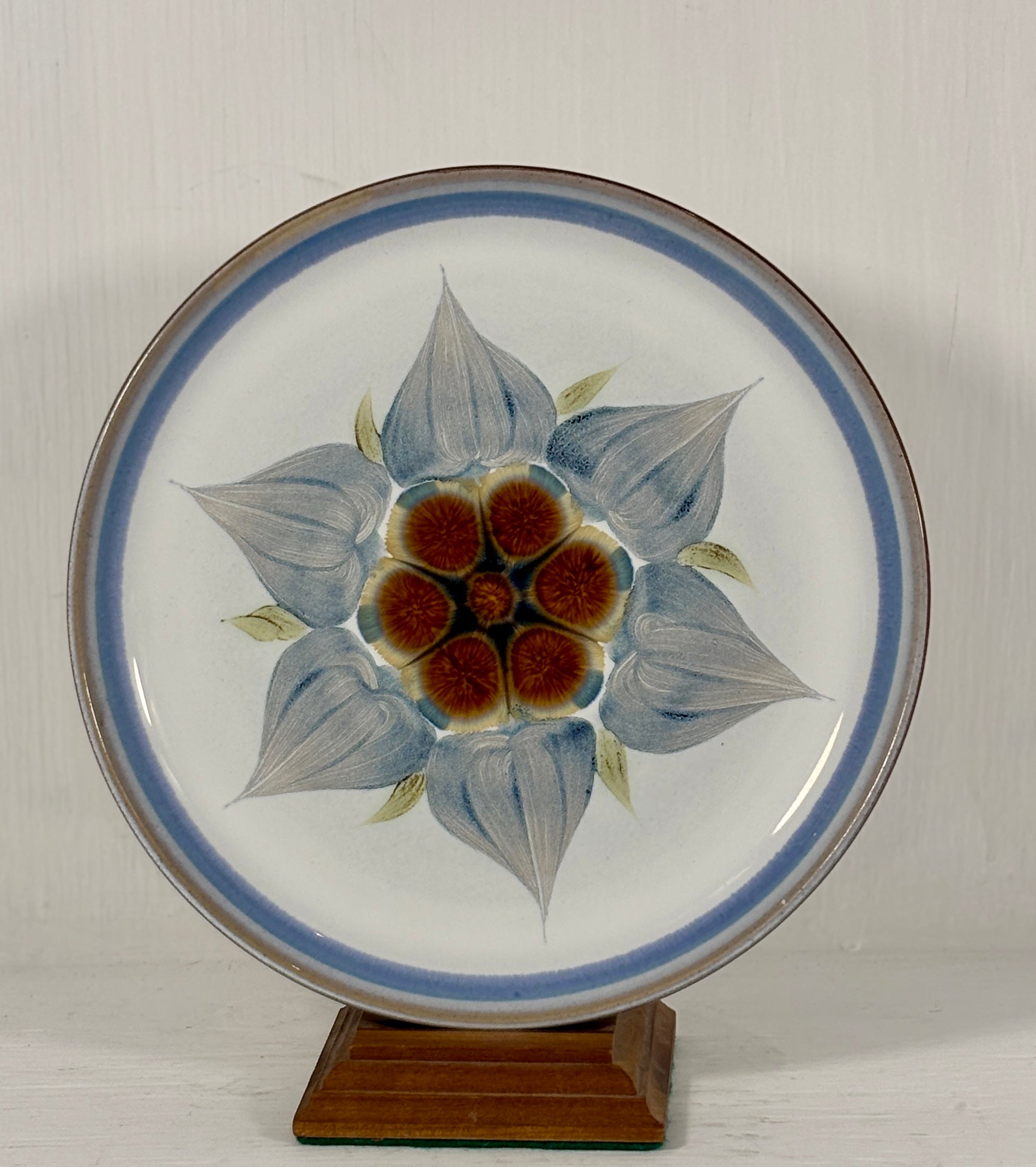 Salad plate with floral design on a stand against a white background