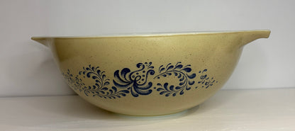 Beige bowl with blue floral patterns on a white background