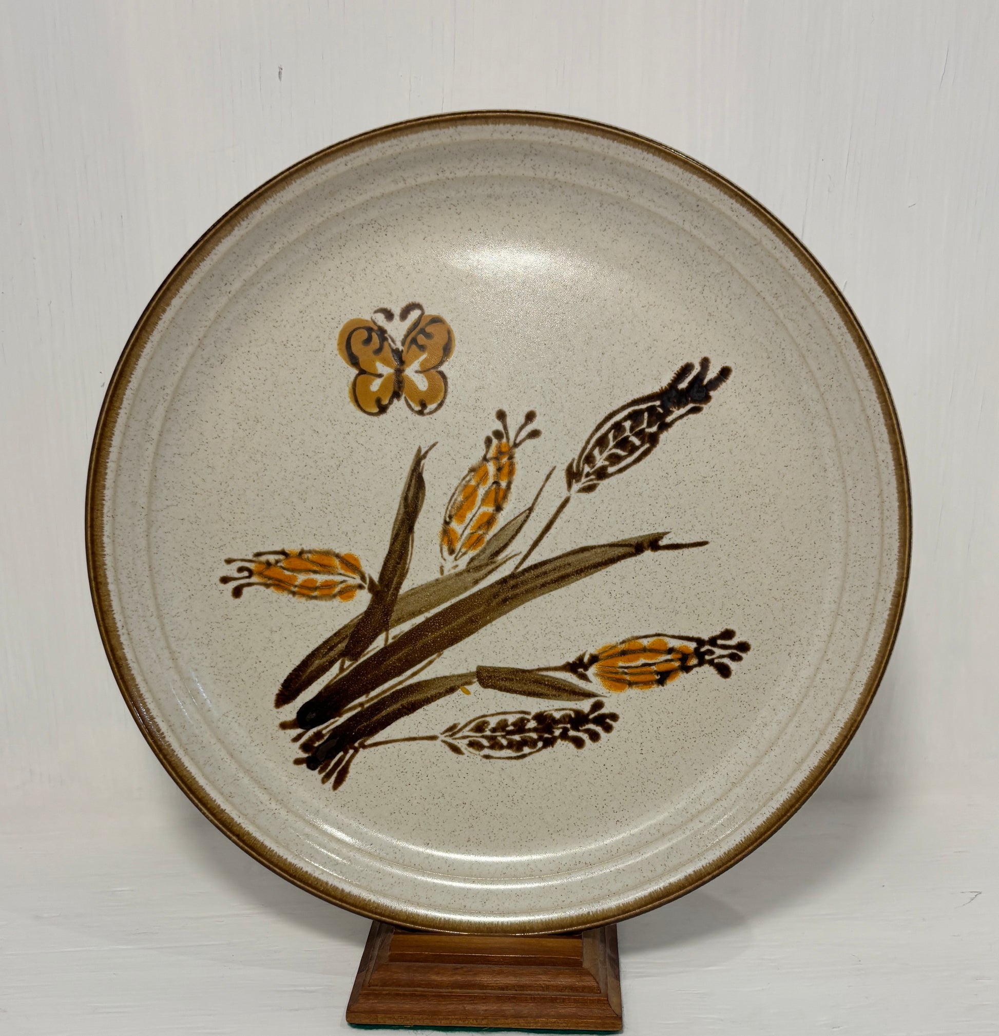 Ceramic plate with brown floral design on a white background