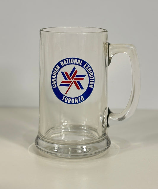 Clear glass mug with Canadian National Exhibition Toronto logo on a white background