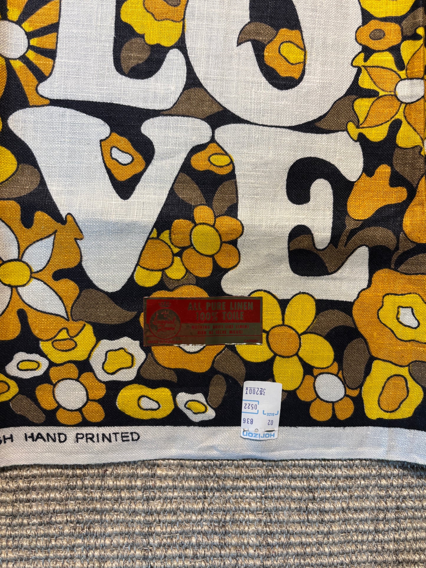 Floral patterned fabric with 'LOVE' text and a visible label.