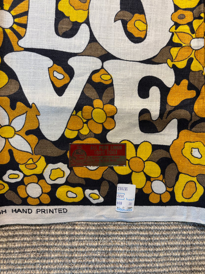 Floral patterned fabric with 'LOVE' text and a visible label.