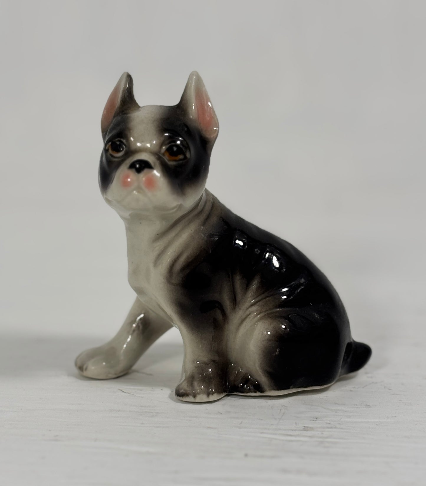 Ceramic figurine of a Boston Terrier on a white background