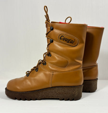 Pair of brown leather boots with 'Cougar' branding on a white background
