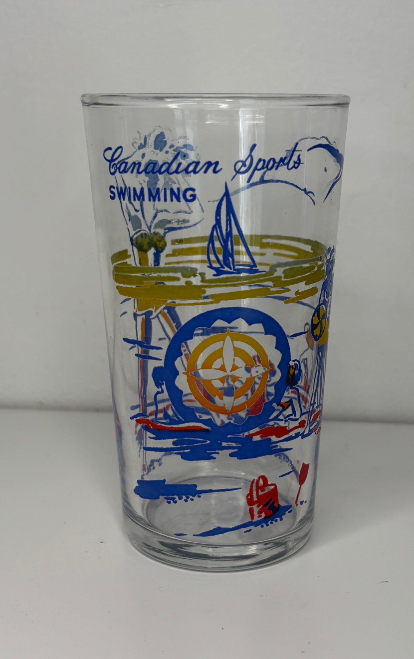 Glass with Canadian Sports Swimming design on a white background