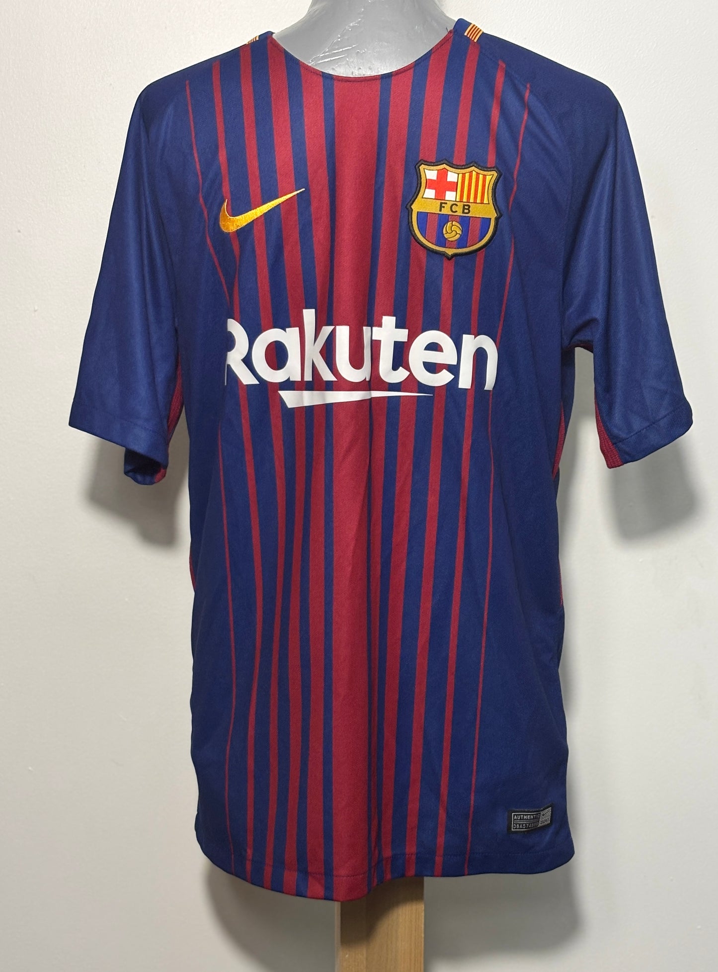 FC Barcelona home soccer jersey by Nike, featuring blue and red vertical stripes, a yellow Nike swoosh, and the FC Barcelona crest on the chest, displayed on a mannequin torso.