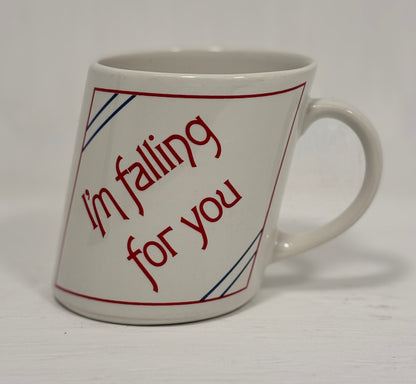 White mug with red text 'I'm falling for you' on a white background