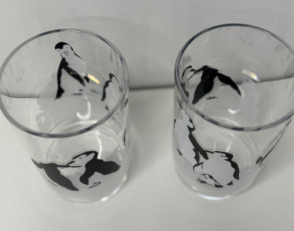 Two glass tumblers with black and white illustrations on a white background