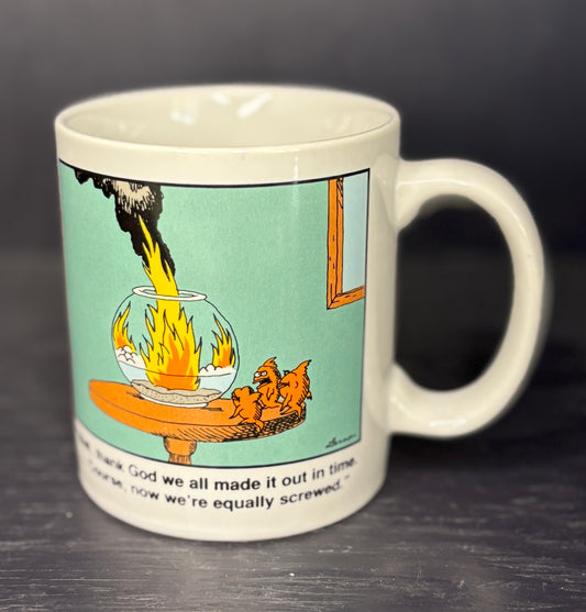 Mug with a humorous cartoon design on a dark surface