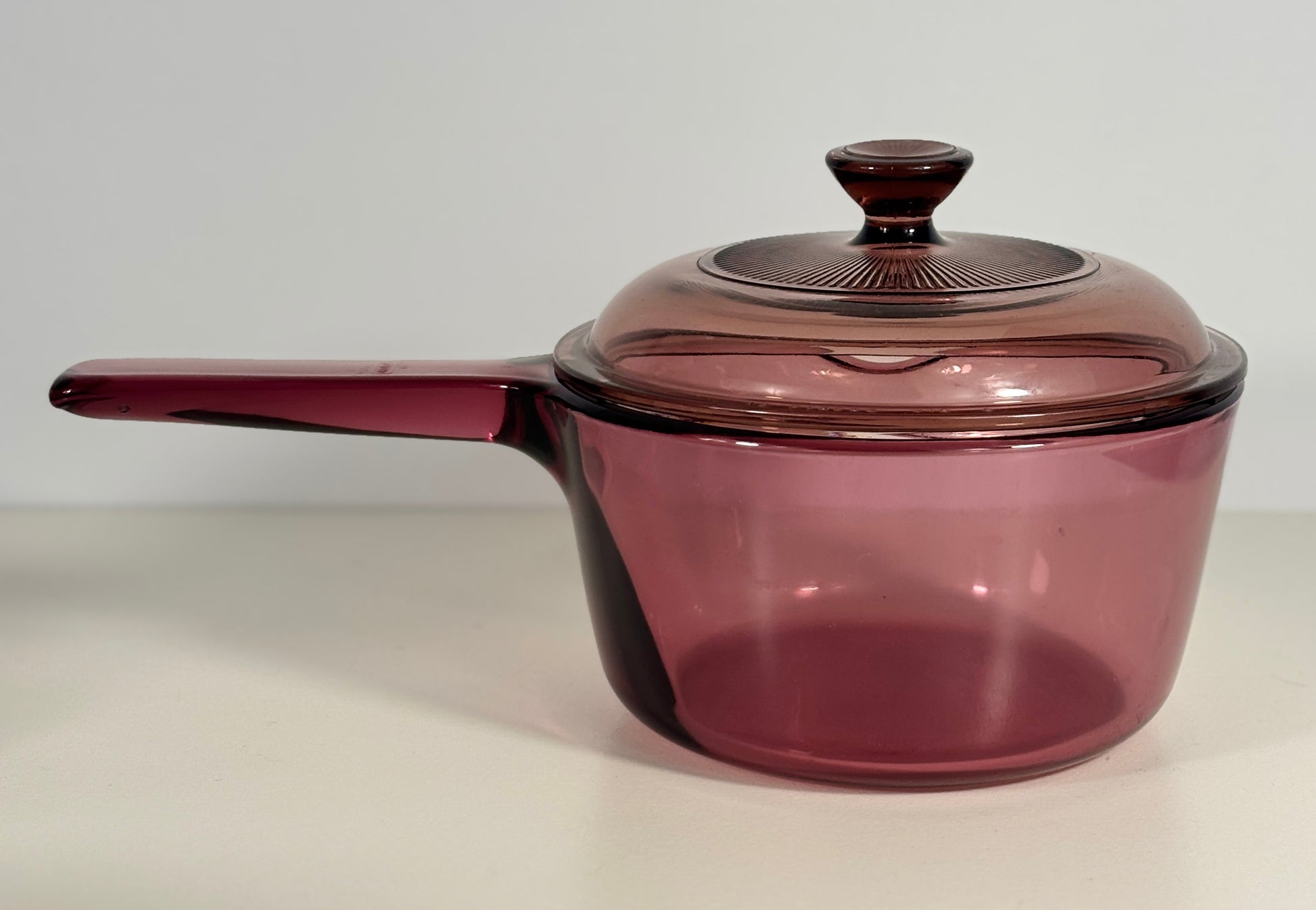 Purple cookware with a lid on a white background