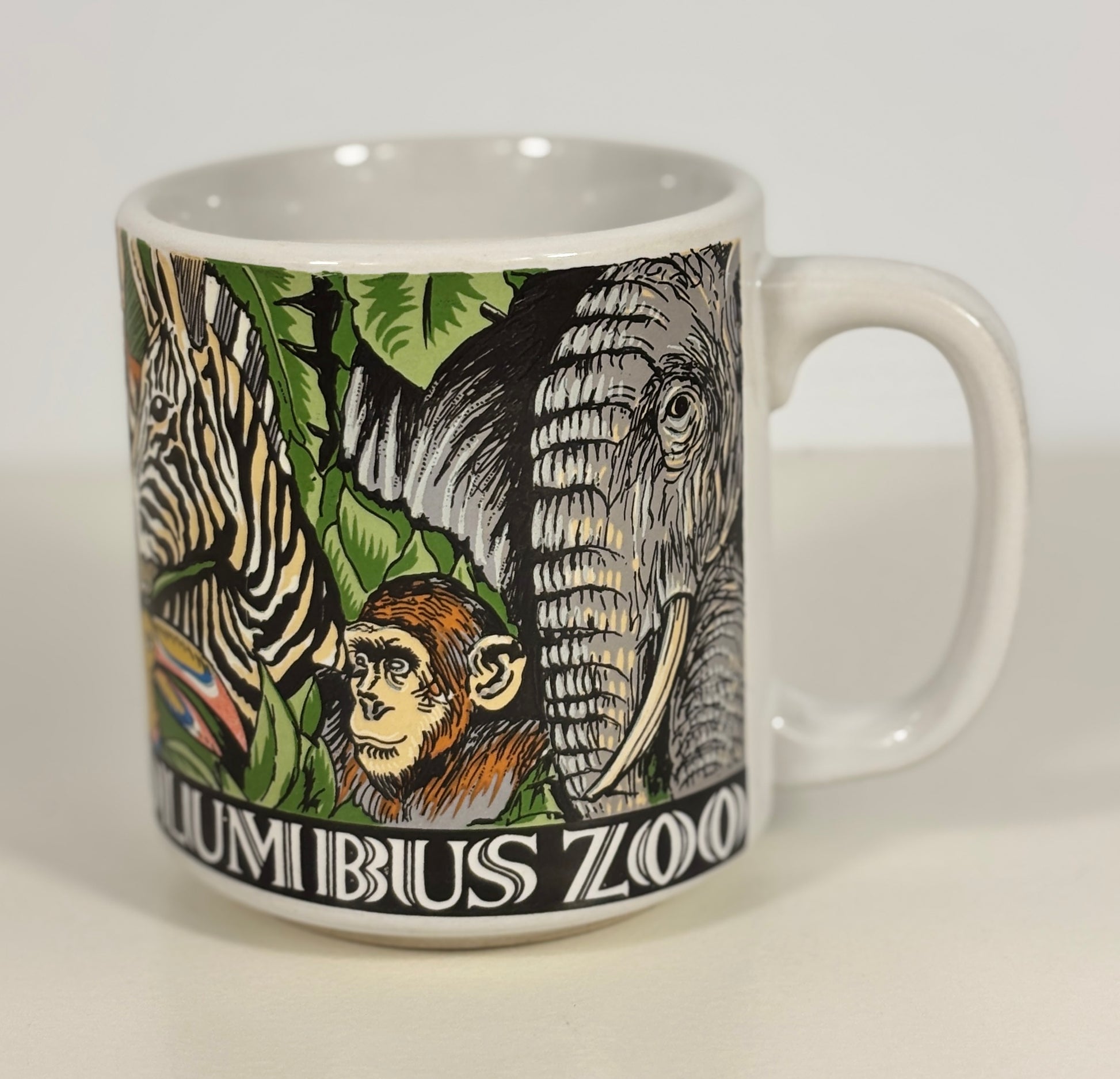 Mug with Columbus Zoo design featuring animals on a white background