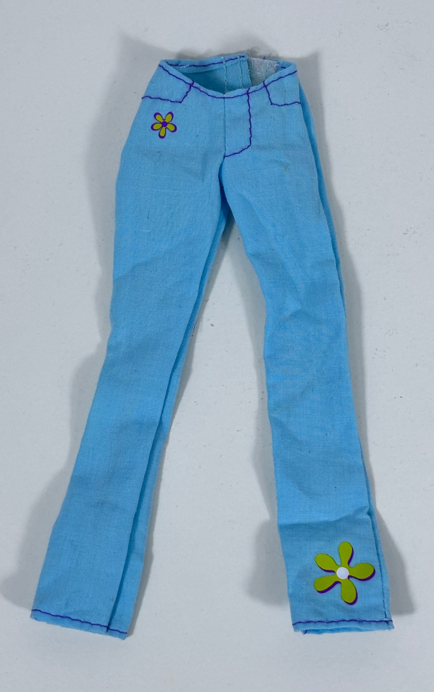Light blue denim-style pants with embroidered flower details on the upper left thigh and lower right leg, shown flat against a light gray background.