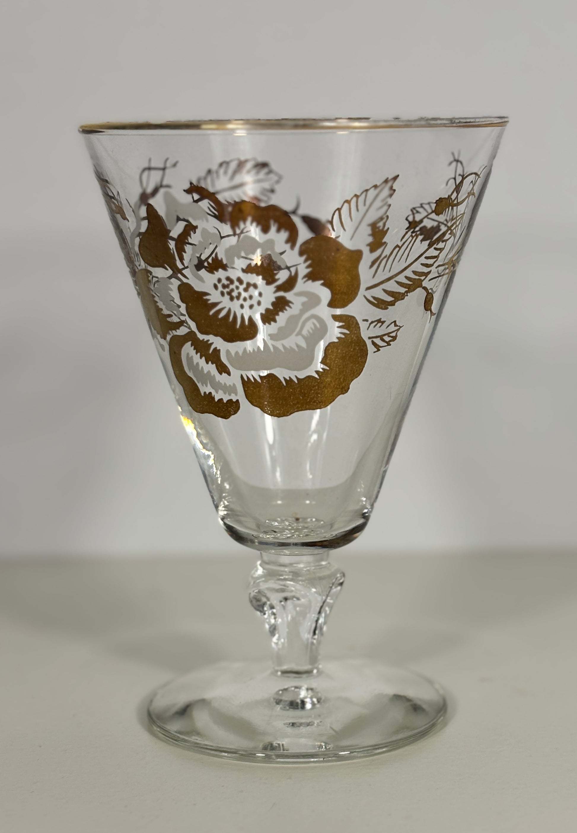 Decorative glass with floral pattern on a plain background
