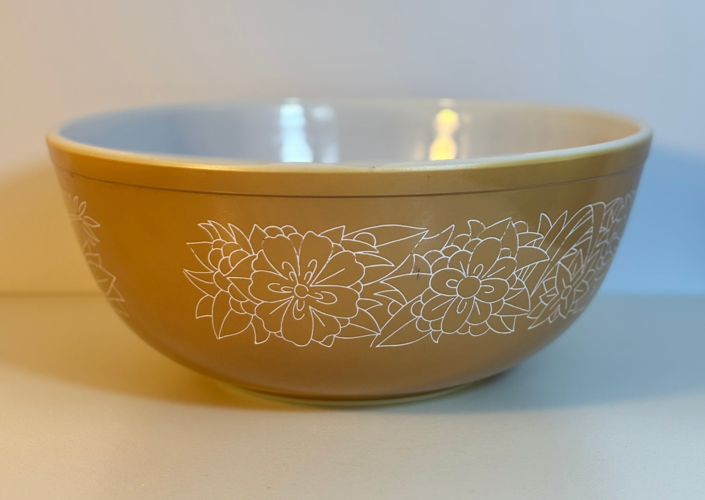 Beige bowl with floral design on a light background