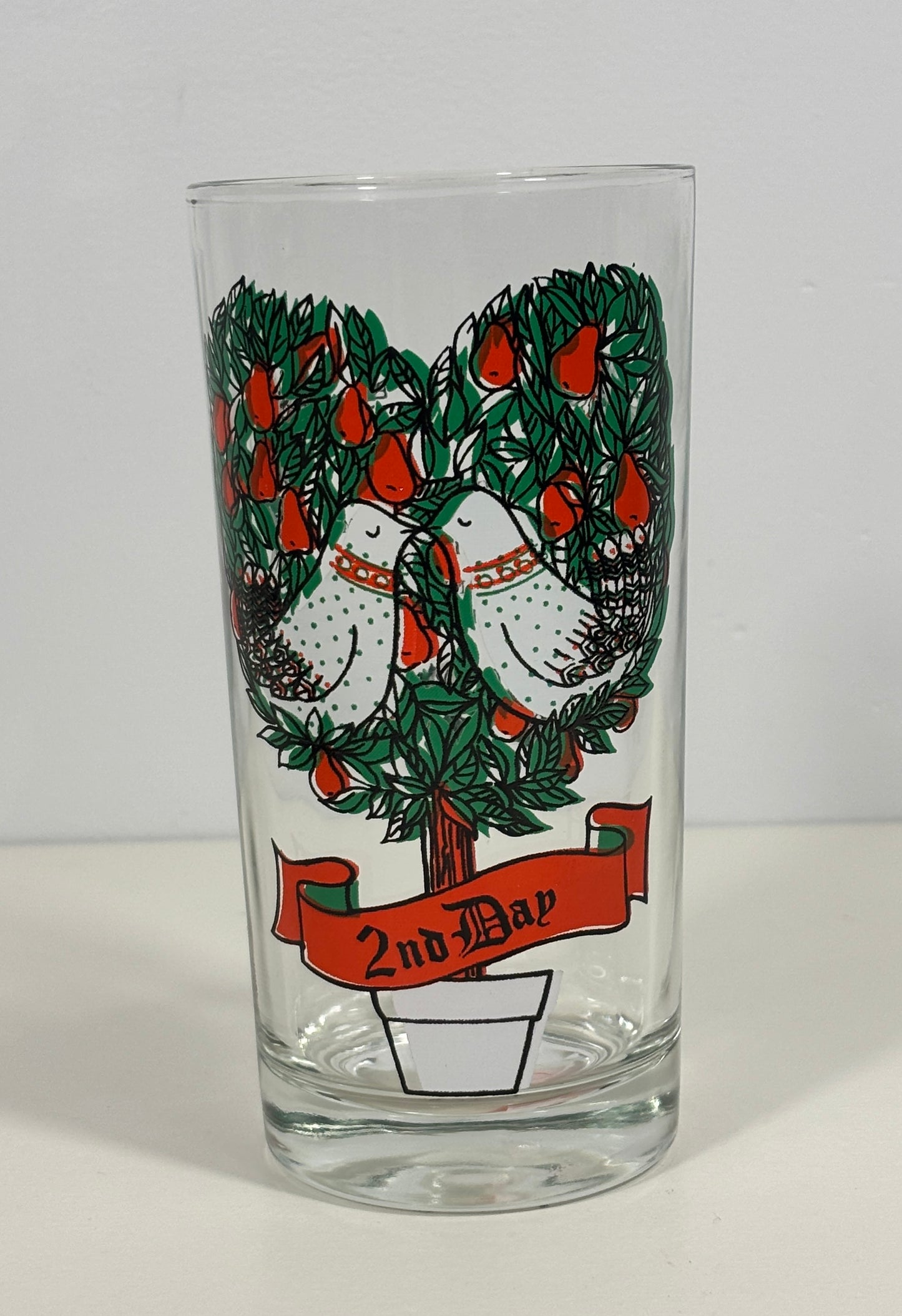 A clear glass tumbler featuring a vintage-style illustration of two white doves kissing under a heart-shaped tree with red apples, with a red banner below reading '2nd Bar'.