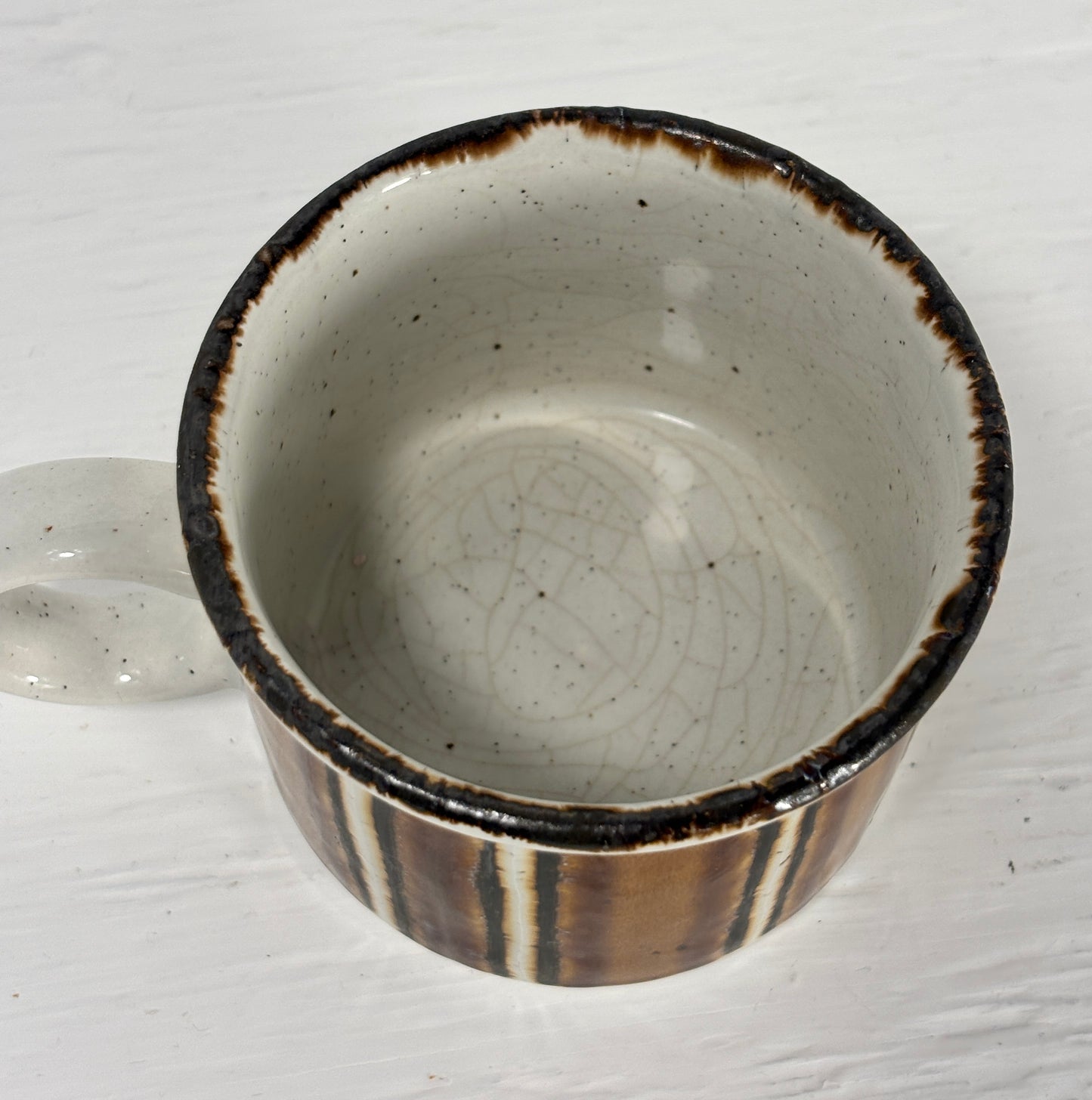 Ceramic bowl with brown rim and interior on a white background