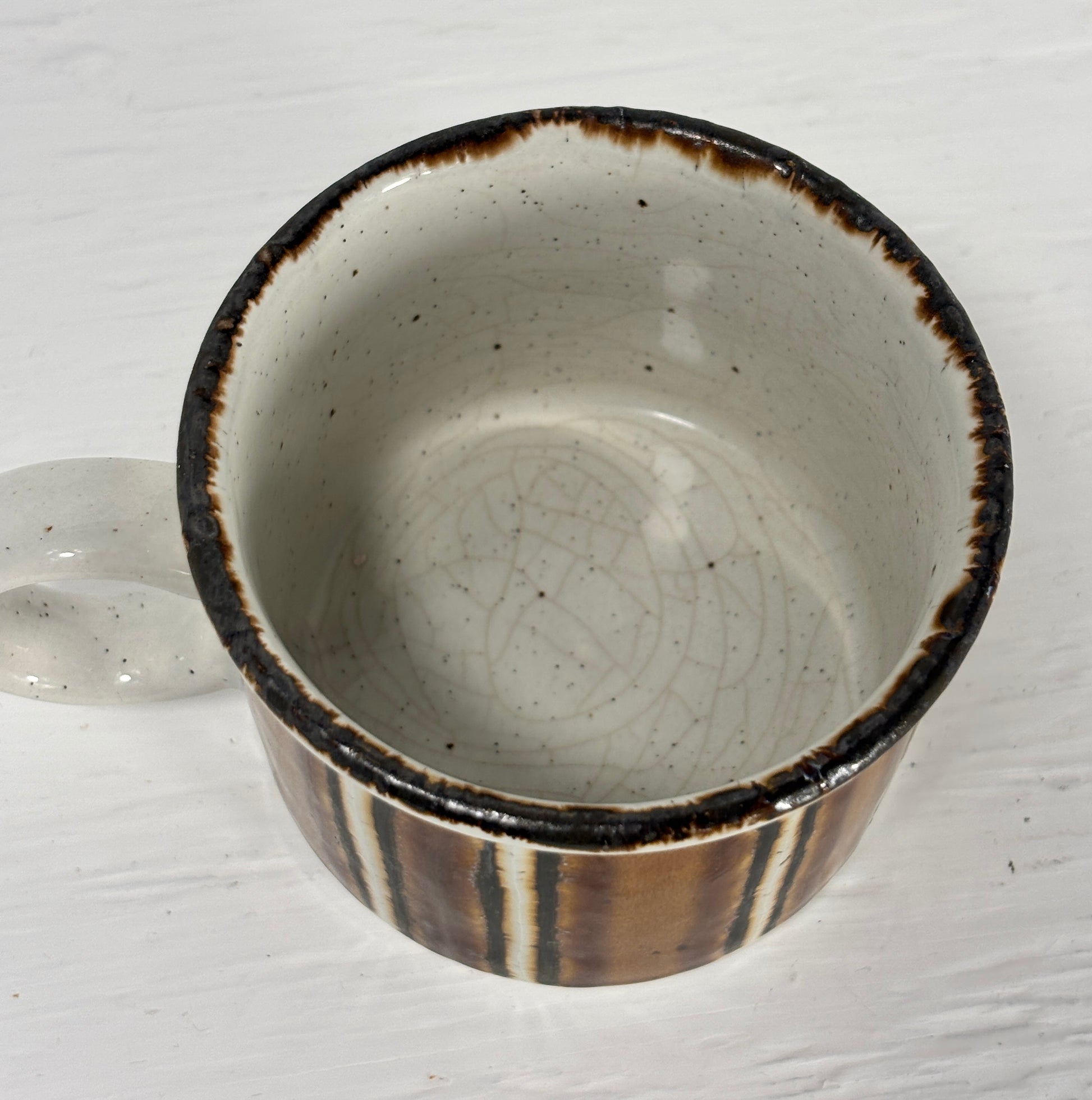 Ceramic bowl with brown rim and interior on a white background