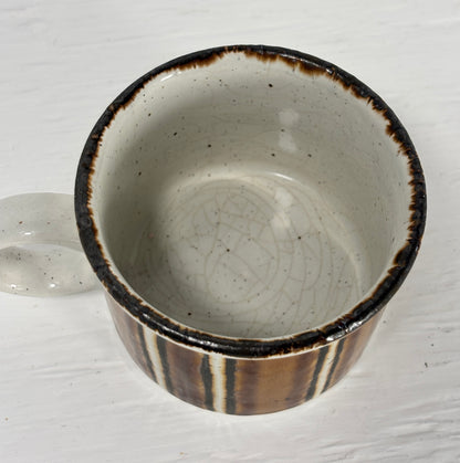 Ceramic bowl with brown rim and interior on a white background