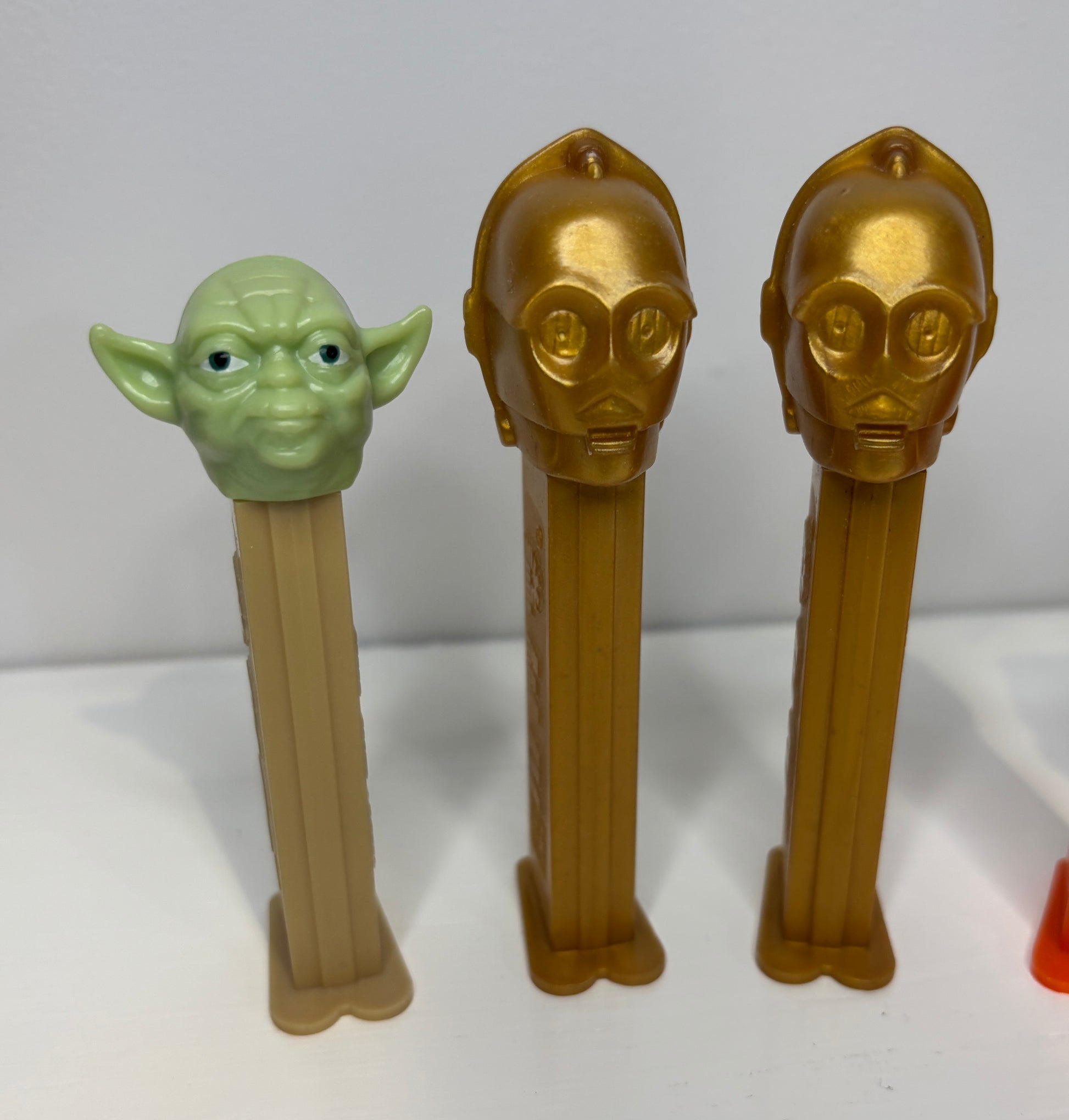 Three Star Wars-themed Pez dispensers on a white background