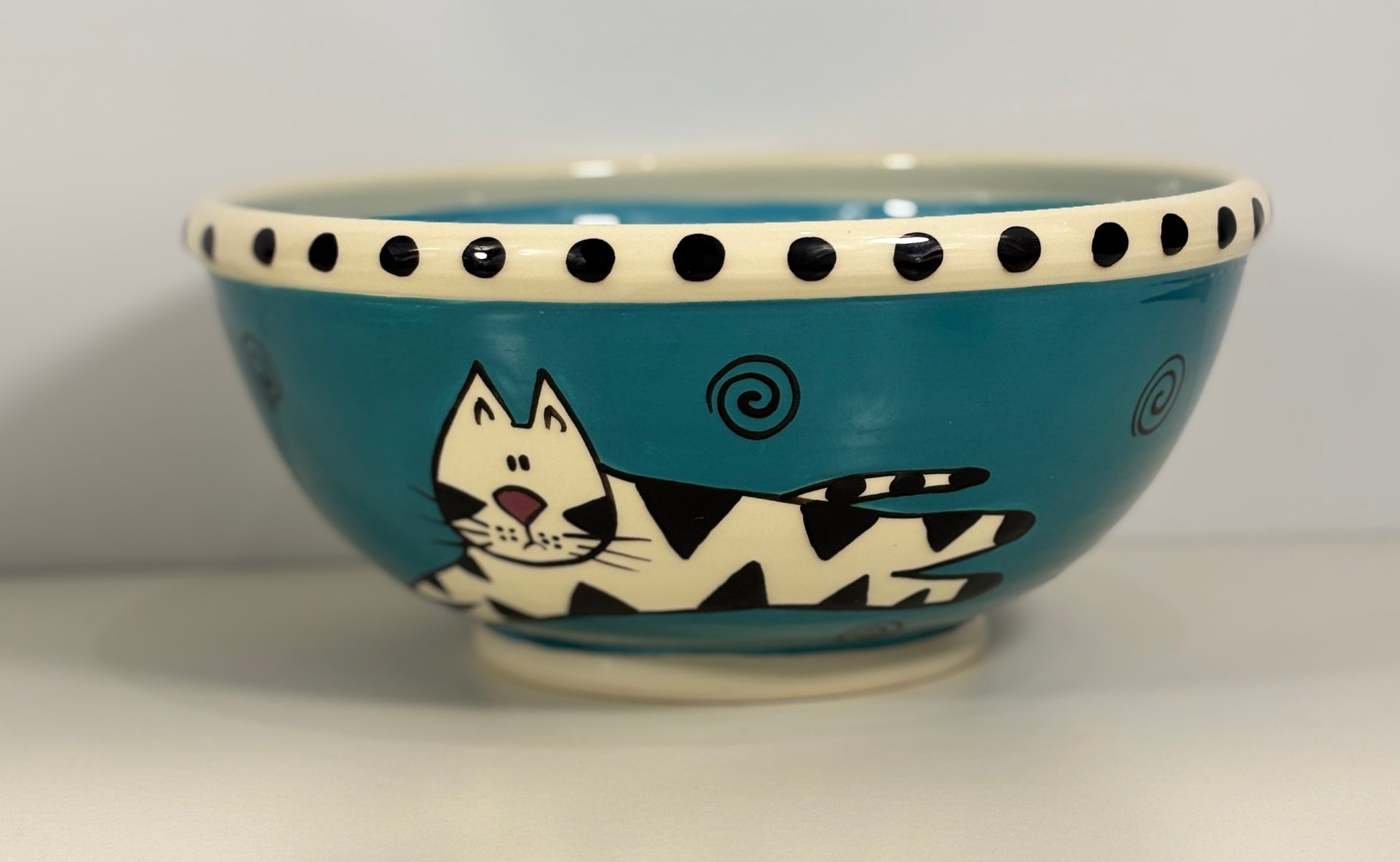 Ceramic bowl with a cat design on a white background