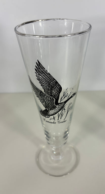 Clear glass with black eagle design on a white surface