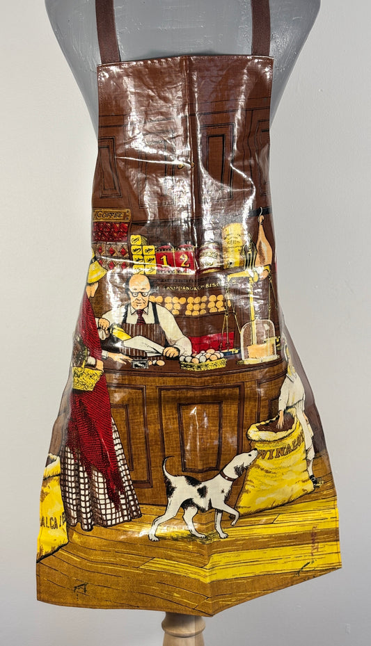 Vintage-style apron with a printed design of a market scene on a mannequin.
