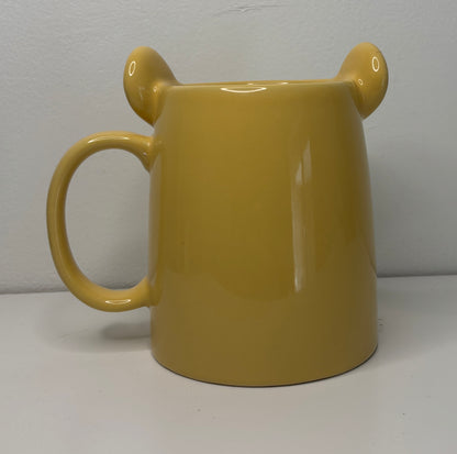 Yellow mug with bear ears on a white background