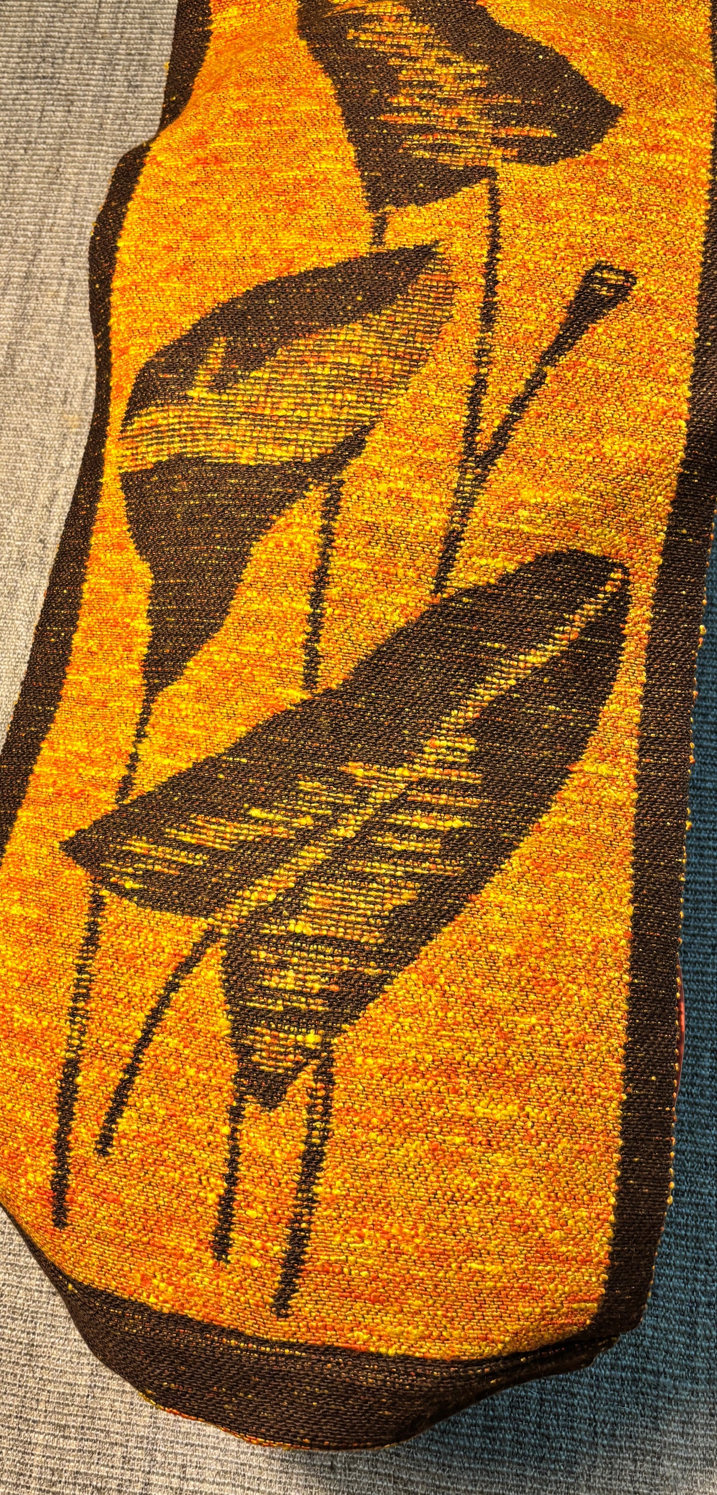 Textile with black leaf pattern on a yellow background