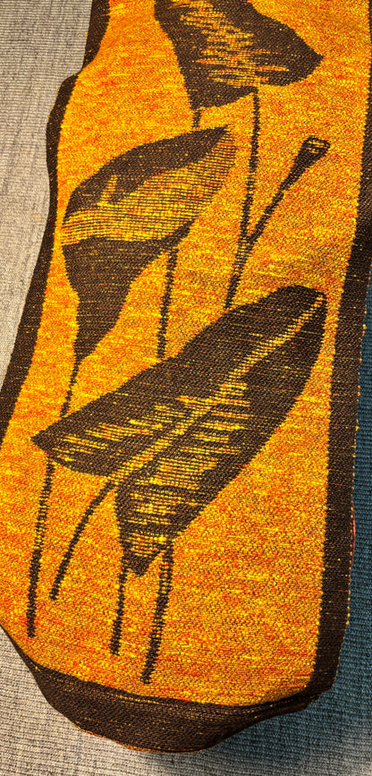 Textile with black leaf pattern on a yellow background