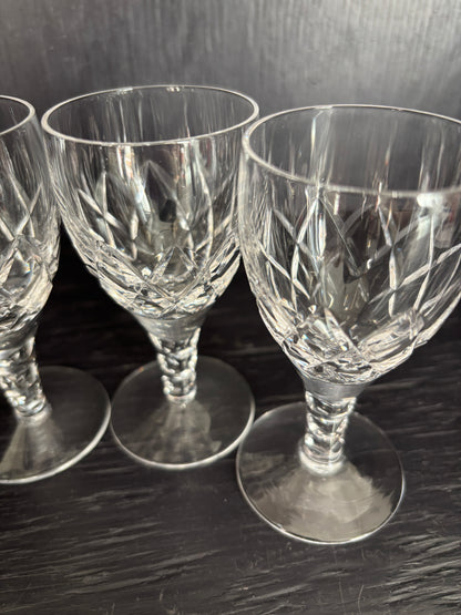 Three crystal glasses on a reflective surface
