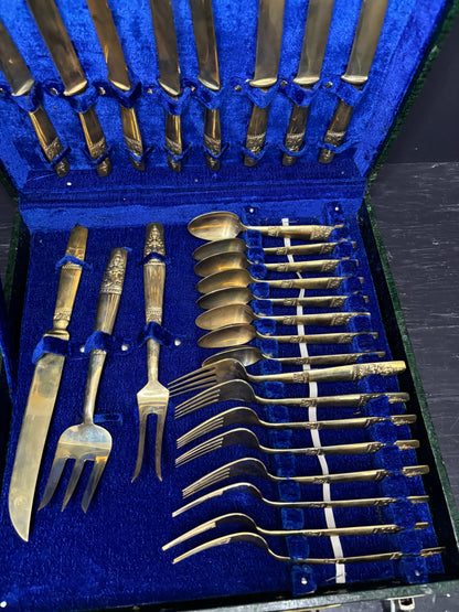 Set of silver cutlery including forks and spoons in a blue case.
