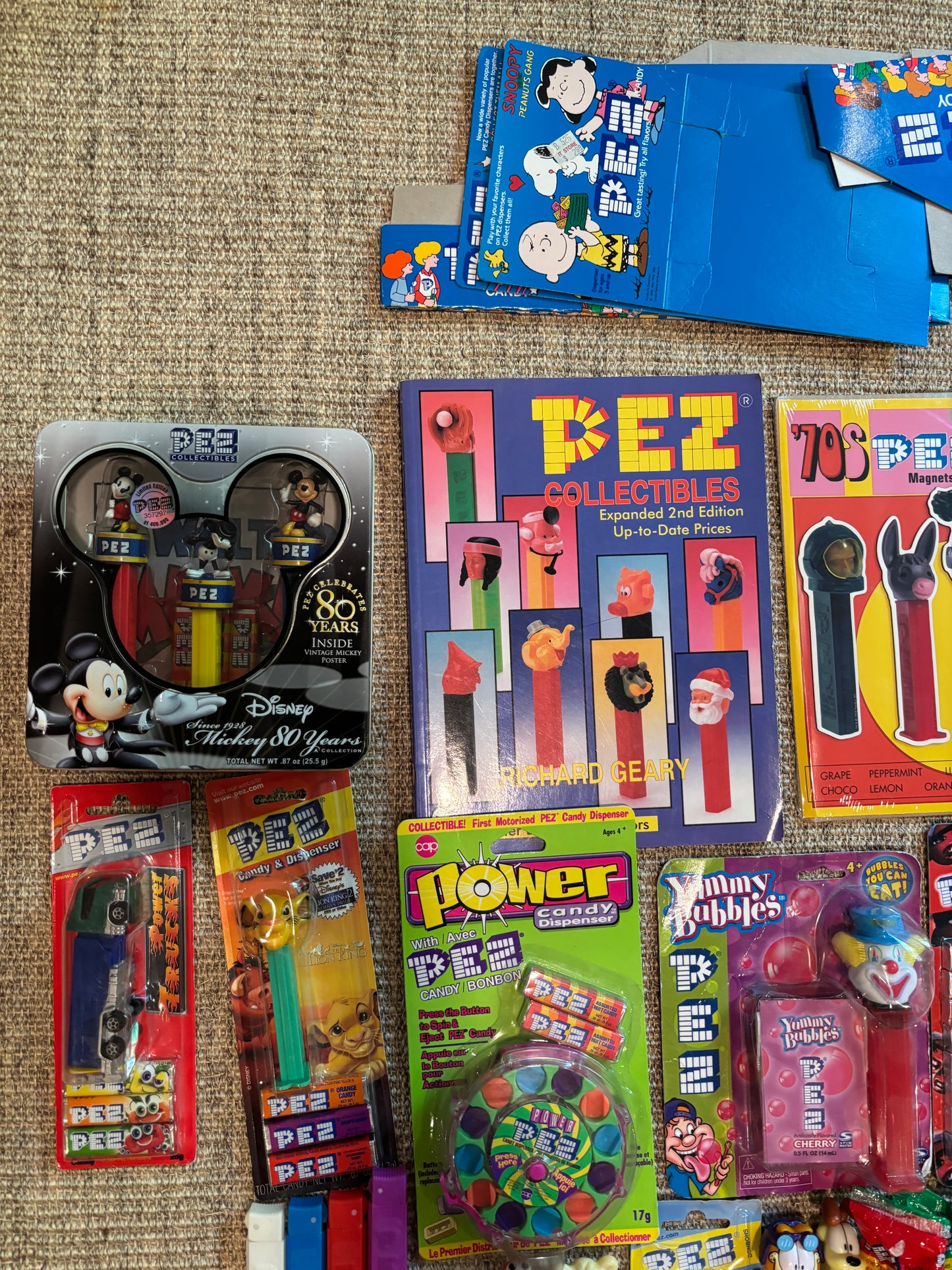 Collection of vintage PEZ candy containers on a textured surface