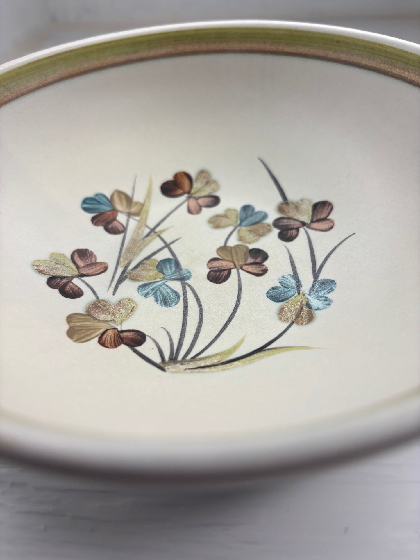 Ceramic plate with floral design on a plain background