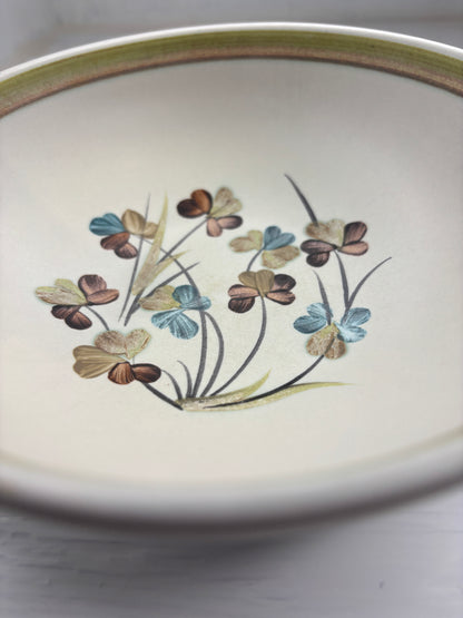 Ceramic plate with floral design on a plain background