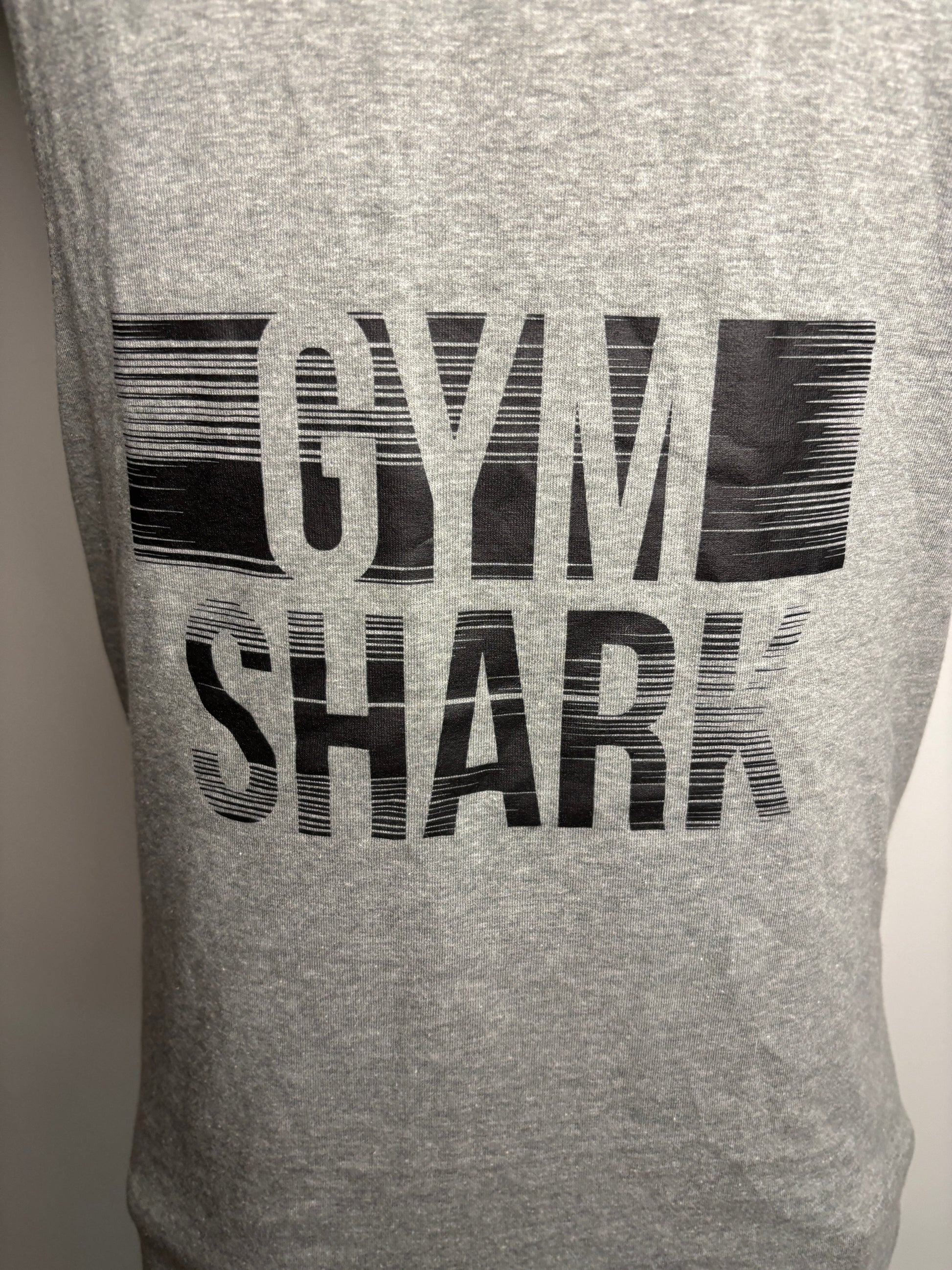 Gray t-shirt with 'Gym Shark' branding on a plain background