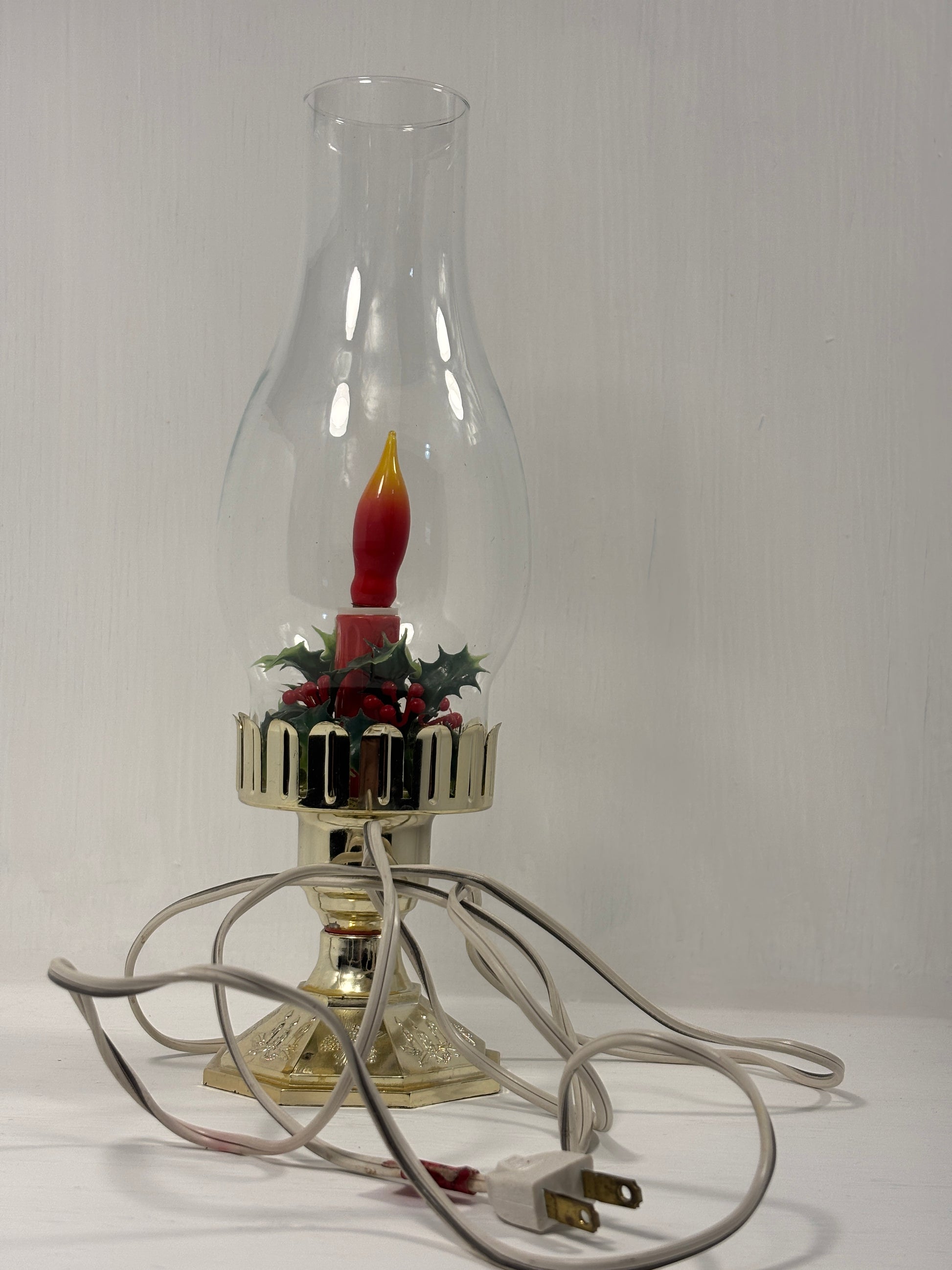 Decorative lamp with a candle-like figure inside on a white background