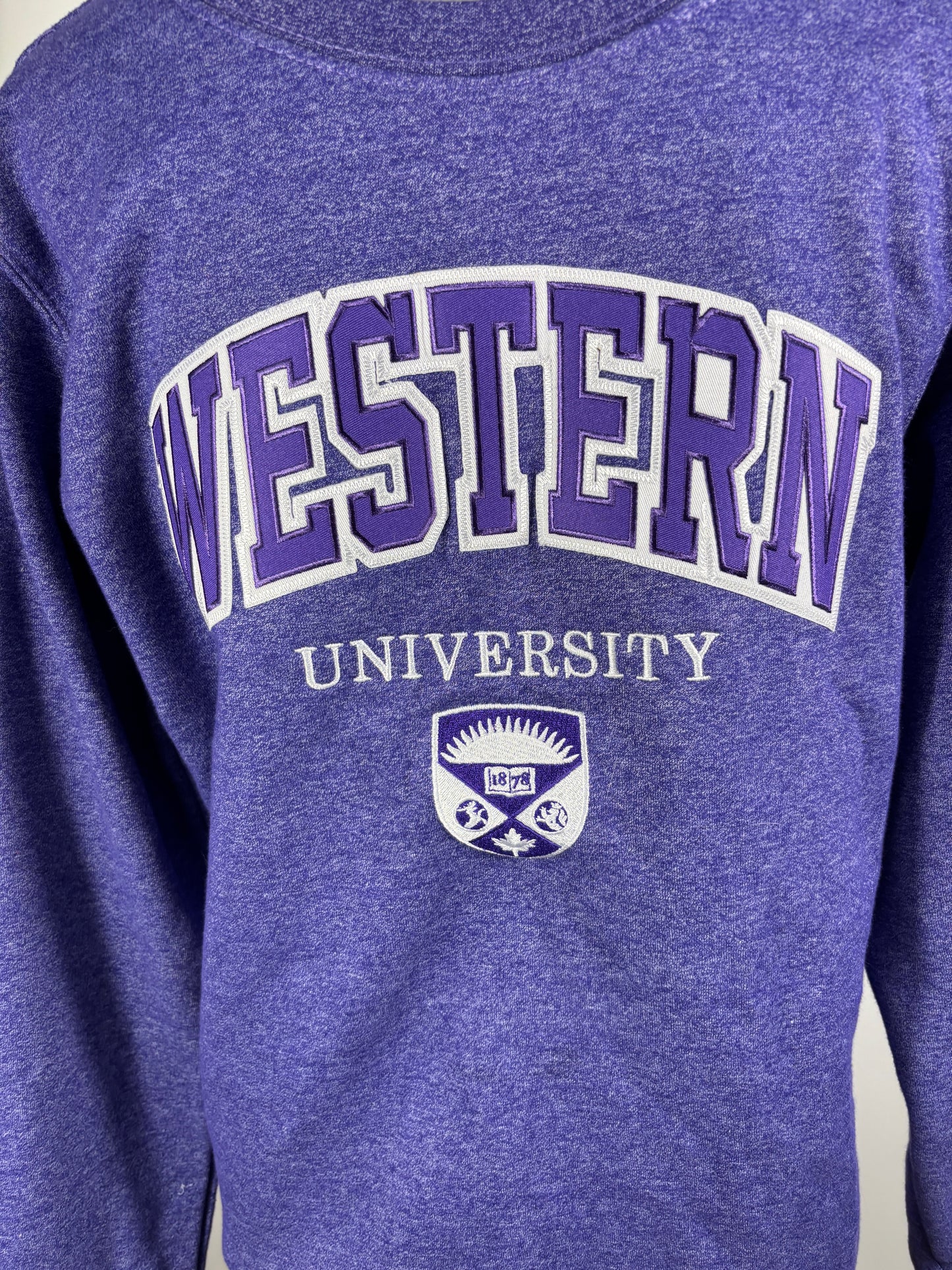 Purple sweatshirt with 'Western University' text and logo