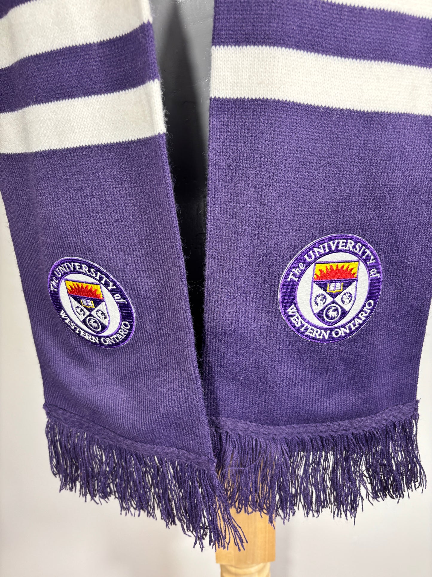 Purple scarf with white stripes and a logo, featuring the University of Oxford emblem.