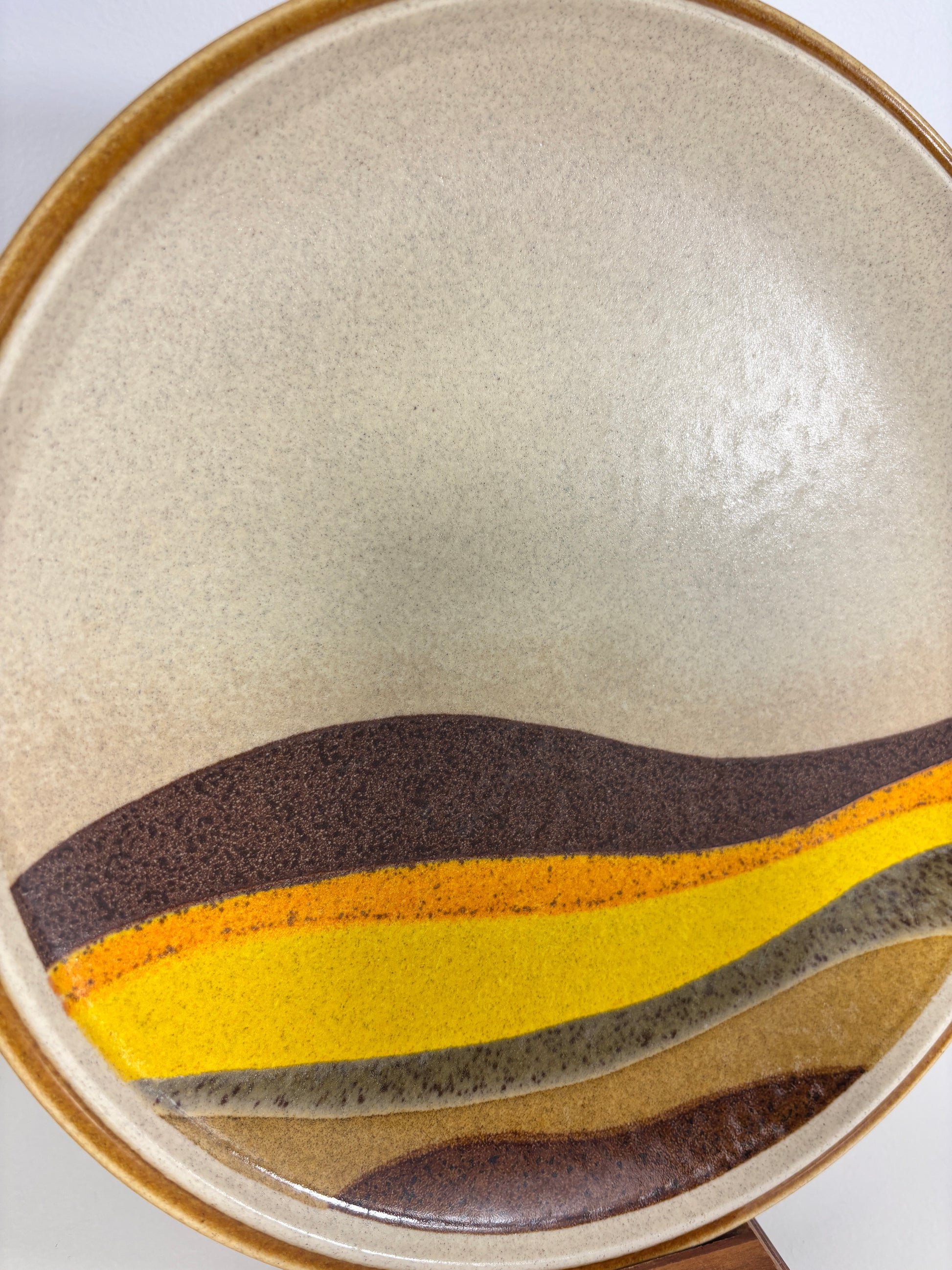 Close-up of a ceramic plate with a textured surface and colorful design.