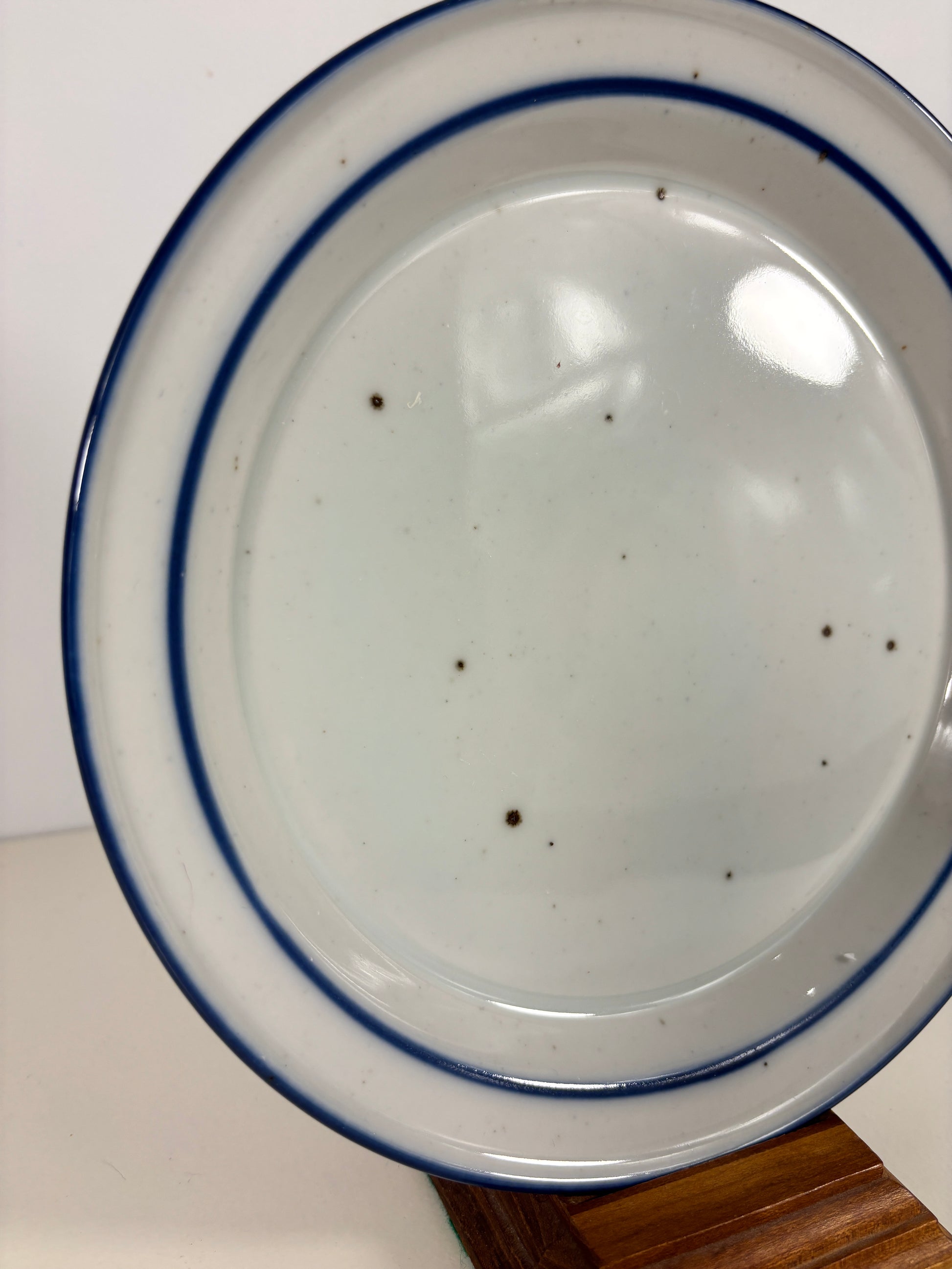 Ceramic bowl with blue rim on a white surface