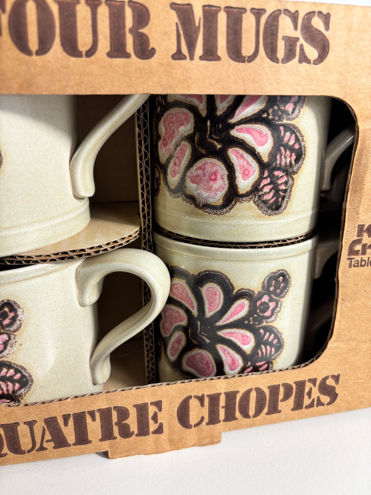 Set of four mugs with floral designs in a branded box