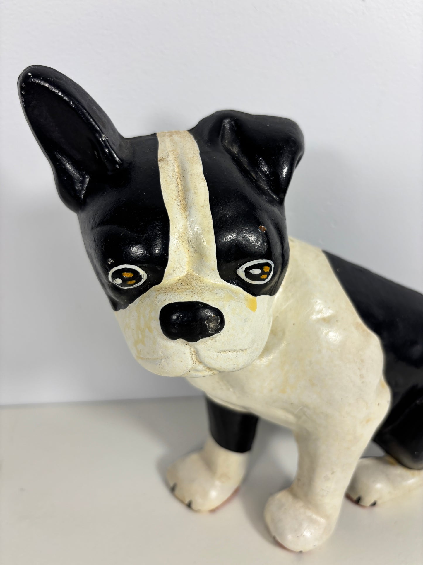 Black and white ceramic dog figurine on a plain background