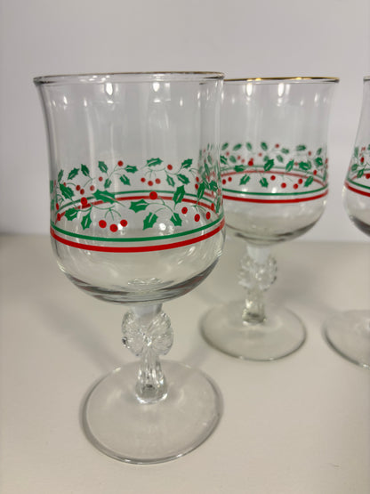 Clear glass tumblers with red and green decorative bands on a white background