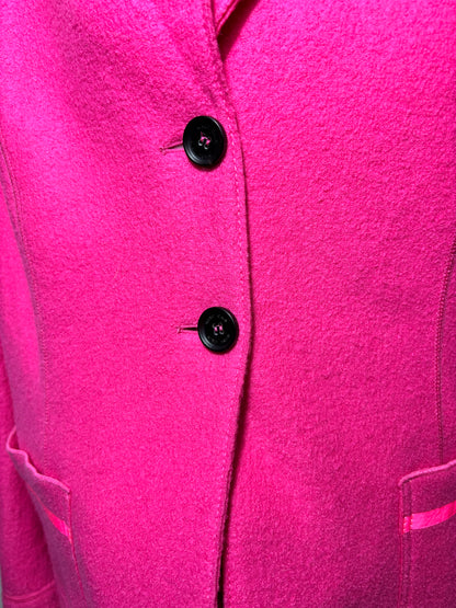 Close-up of a bright pink coat with black buttons