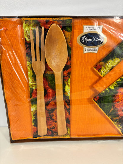 A boxed set of orange napkins and wooden cutlery, including a fork and spoon, with a visible 'Elegant Party' brand label on the packaging.