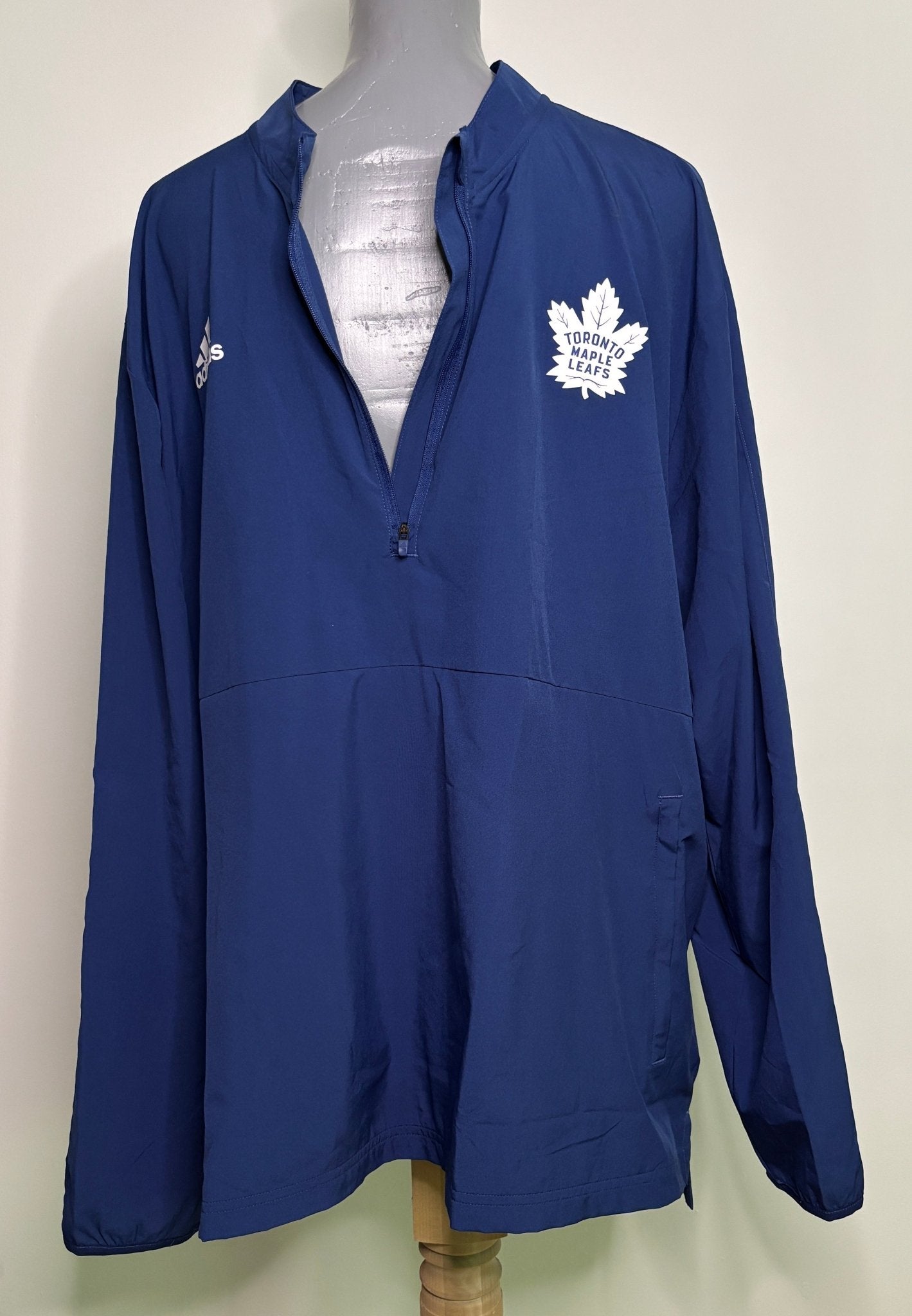 Blue jacket with a logo on a mannequin against a white background