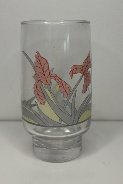 Clear glass tumbler with floral design on a white background