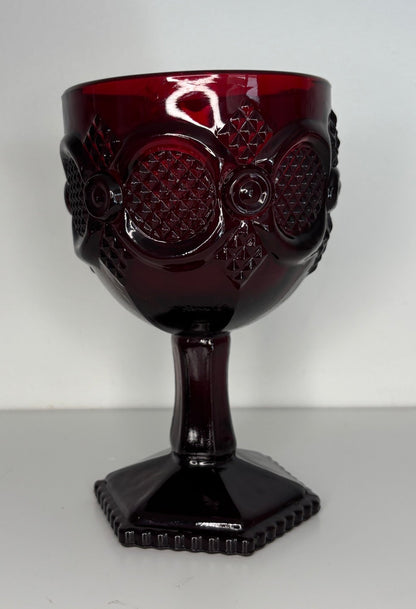 Red glass goblet with design on a white background